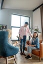 Dark-haired tall man standing next to his girlfriend Royalty Free Stock Photo