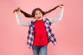 Being such a good girl. Pigtailed little girl pink background. Happy girl hold long hair. Small girl smile in casual Royalty Free Stock Photo