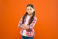 Being upset. childhood memory. little girl orange background. kid fashion. serious school girl. worker uniform. kid long