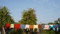 Clothes drying on a clothesline, Clean washing hanging on clothesline hung in backyard Royalty Free Stock Photo