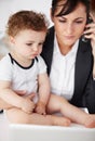 Being a working mom can be tricky...Young working mother talking on the phone while holding her baby. Royalty Free Stock Photo