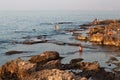BEIRUT, LEBANON - AUGUST 14, 2014: Unknown people resting on the stones coast of the Mediterranean coast in the Raouche district Royalty Free Stock Photo