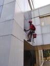 Bekasi, Indonesia, August, 11, 2021 : Workers are cleaning a building at a height Royalty Free Stock Photo