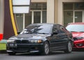 Bekasi -Indonesia, September 8, 2022. A black BMW car parked in an office area, in a cloudy atmosphere. the car still looks cool.