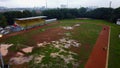 Aerial view of a work day off in the morning at the school stadium. Overhead aerial drone flight over sports people