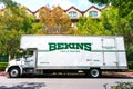 Bekins Van Lines moving company truck waits for customers at an outdoor parking lot near an apartment. Bekins is a nationwide Royalty Free Stock Photo