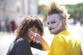 Guy punk with a beautiful girl in bright clothes on a city street