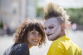 Guy punk with a beautiful girl on a city street