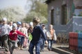 A crowd of preschoolers chasing a boy