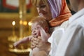 A baby baptized by mom in her arms