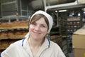 Beautiful woman cook at the factory in the bakery shop