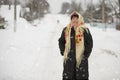 Russian woman in a scarf on a village background