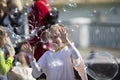 Joyful children in the street catch soap bubbles Royalty Free Stock Photo