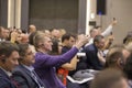 Public event. Spectators at the conference with translators and telephones