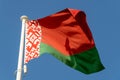 Belarus Flag hanging and blowing in sunshine on blue sky background Royalty Free Stock Photo