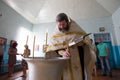 The priest prepares for the rite of baptism