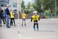 Childrens competition in roller sport.A girl on roller skates jumping over a sports