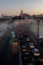 Belarus, Grodno July 15, 2022: The movement of cars and public transport on the bridge over the river. Thick morning fog over the