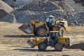 BELAZ-78221 front-end loader and SDLG L953F wheel loader working at mining quarry. Work in open-pit mine Royalty Free Stock Photo