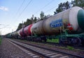 Freight train with petroleum tank cars GAZPROM TRANS on railroad. Railway logistics explosive cargo.
