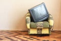 Belarus, Minsk - June 03, 2019:Sony trinitron kv-21m3.The old TV lies in a vintage armchair.Old design in a home.