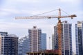 LIEBHERR tower crane constructing a new residential building at a construction site against blue