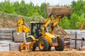 Belarus, Minsk - May 28, 2020: Bulldozer or tractor industrial machine at a construction site against the background of a large