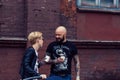 Belarus, Minsk, may 17, 2015, Oktyabrskaya street, biker festival. couple of bikers drinking coffee near the city