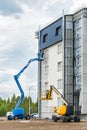 Belarus, Minsk - May 28, 2020: A worker on a lifting platform paints the facade of a new modern urban building under construction Royalty Free Stock Photo