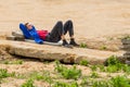 Belarus, Minsk - May 28, 2020: Young worker guy on a break resting, sleeping on an old concrete slab at a construction site Royalty Free Stock Photo