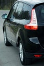 Belarus, Minsk-October 6, 2019:Black car Renault Grand Scenic stands on the road,side view. Photographing a modern car in the park