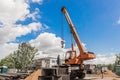 Belarus, Minsk region - May 20, 2020: Machine Beam Crane Heavy Lifting Industry Vehicle Construction Work on Industrial Site