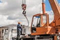 Belarus, Minsk region - May 20, 2020: Machine Beam Crane Heavy Lifting Industry Vehicle Construction Work on Industrial Site