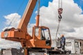 Belarus, Minsk region - May 20, 2020: Machine Beam Crane Heavy Lifting Industry Vehicle Construction Work on Industrial Site