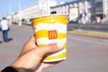 Belarus, Minsk - 03 september, 2022: Glass with a drink from McDonald's in hand Royalty Free Stock Photo