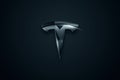 Belarus, October 15, 2021: Tesla company logo on a dark background. Tesla invests in cryptocurrency. Black and silver Tesla logo.