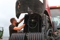Belarus, Vitebsk, July 31, 2020. Farmer mechanic repairs tractor engine.