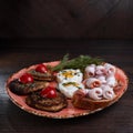 Belarusian breakfast with potato pancakes with scrambled eggs with sour cream with croutons and bacon on a table in a restaurant. Royalty Free Stock Photo