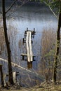 Belarusian landscape. Wooden pier on the lake. A solid spring day in April. Forest river Vyacha. Reflection in water Royalty Free Stock Photo