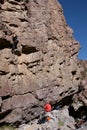 Belayer below climber on wall Royalty Free Stock Photo