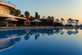 Beldibi, Antalya province, Turkey. 17 October, 2019 Dawn at the hotel near the pool. Silhouettes of palm trees, sunbeds, umbrella Royalty Free Stock Photo