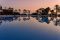 Beldibi, Antalya province, Turkey. 17 October, 2019 Dawn at the hotel near the pool. Silhouettes of palm trees, sunbeds, umbrella Royalty Free Stock Photo