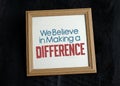 We Beleive in making a difference in wood photo frame Royalty Free Stock Photo