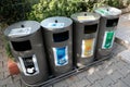 Belek, Turkey - October 2020: Four various trash bins for recycling waste outside. Separate buckets for plastic, paper, glass, non