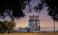 Belem tower under the pink sunset in long-rang view, Lisbon, Portugal