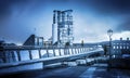 Belfast architecture along River Lagan reflected in a puddle