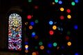 BELFAST, NORTHERN IRELAND, DECEMBER 19, 2018 Detail of a colorful stained glass window from inside of church, seen across a