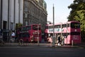 double decker busses lined up in a queue at the square bust stop