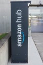 amazon logo on grey hug locker machine in front of the train station