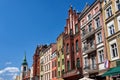 The belfry of a church and facades of historic tenement houses in Torun